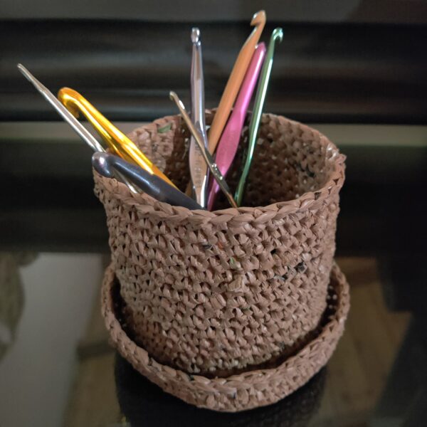 These little cup and dish pair of crocheted plastic containers work great as penholders (or crochet hook holders as shown here) and I've also lined them to use as flowerpots before. They're made of upcycled plastic from used grocery shopping bags.